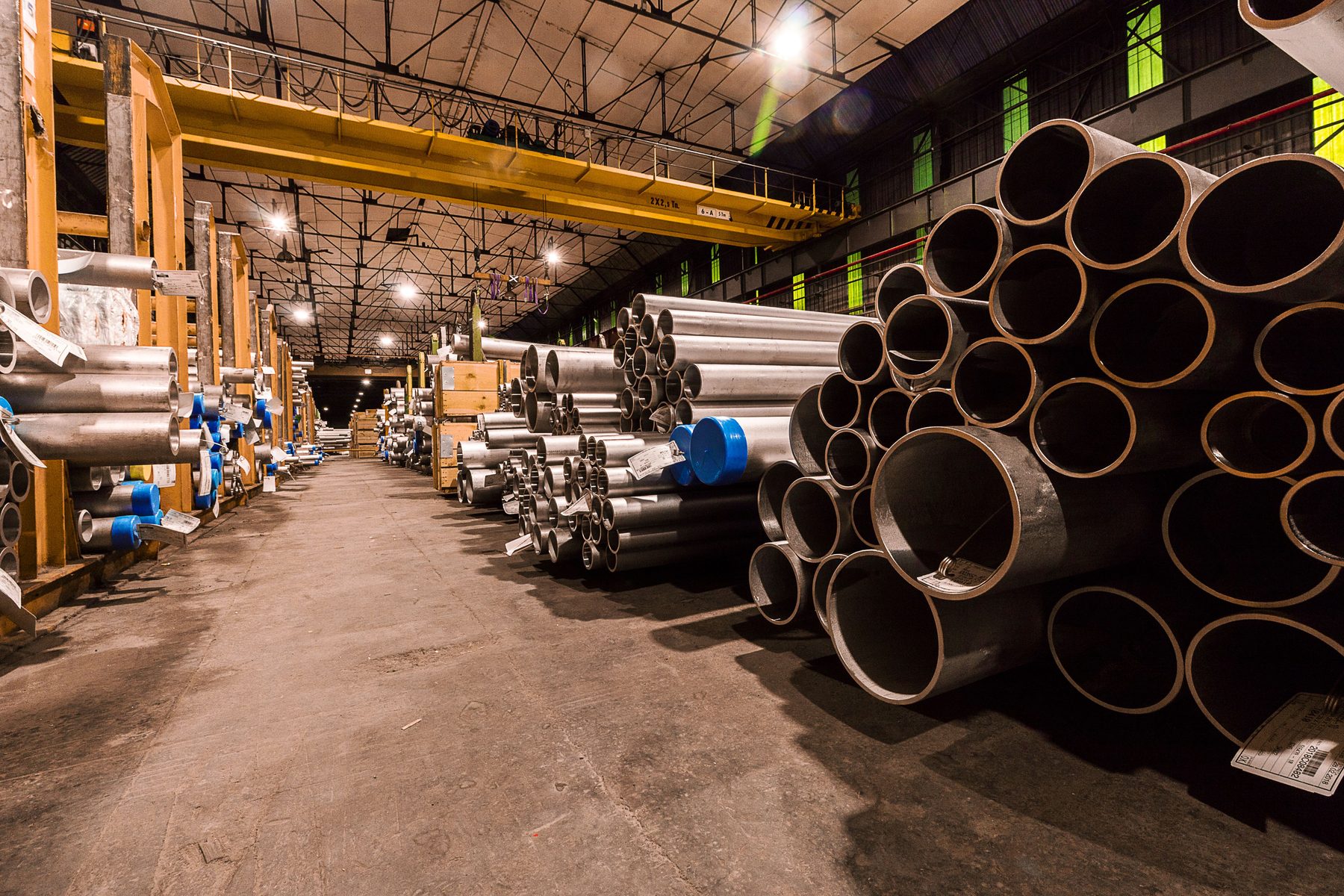 Metal pipes stored in an industrial warehouse